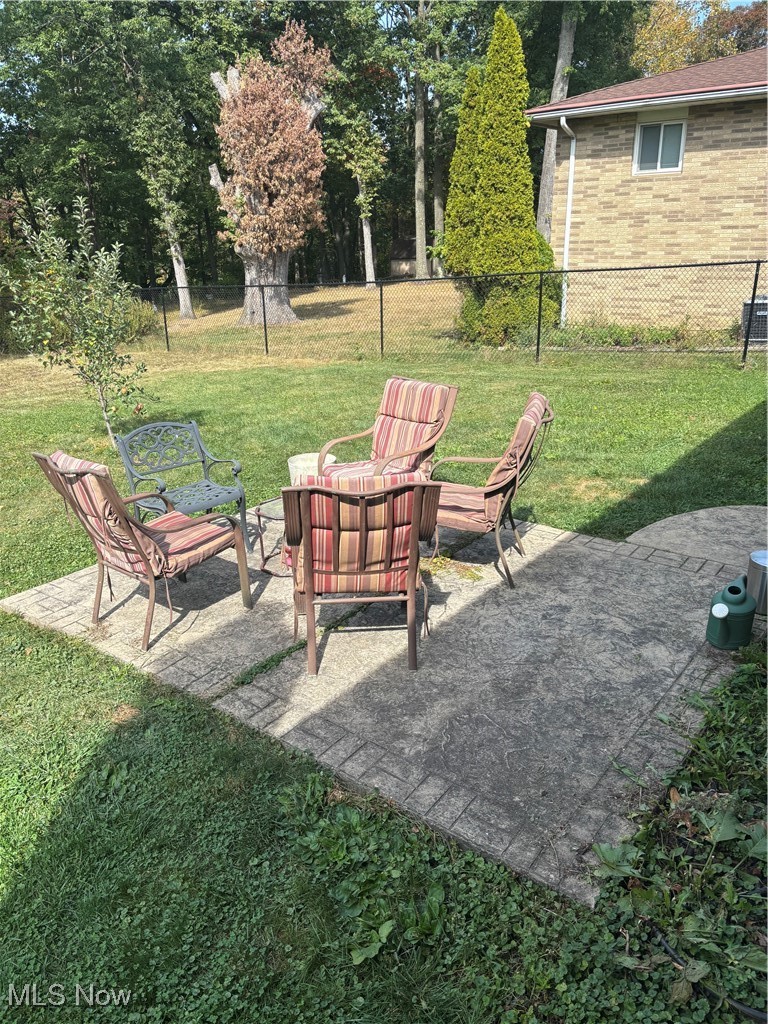 14400 Prospect Road Strongsville, OH 44149 - Photo 19 of 20 View of yard with a patio, a fire pit, and view of wooded area