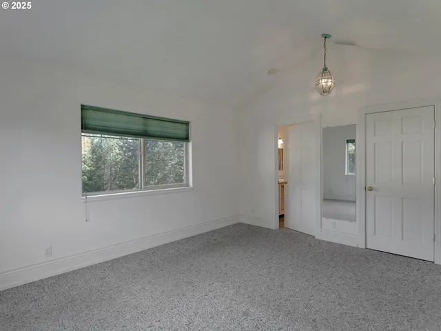 en empty room with windows and closet