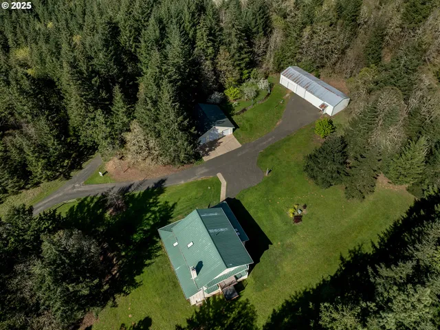 an aerial view of a house with a yard