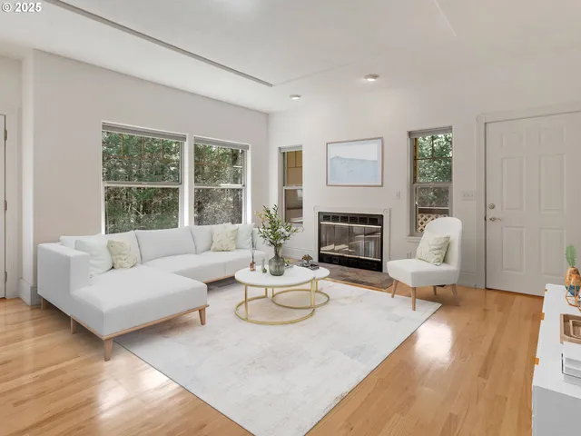 a living room with furniture large window and a fireplace