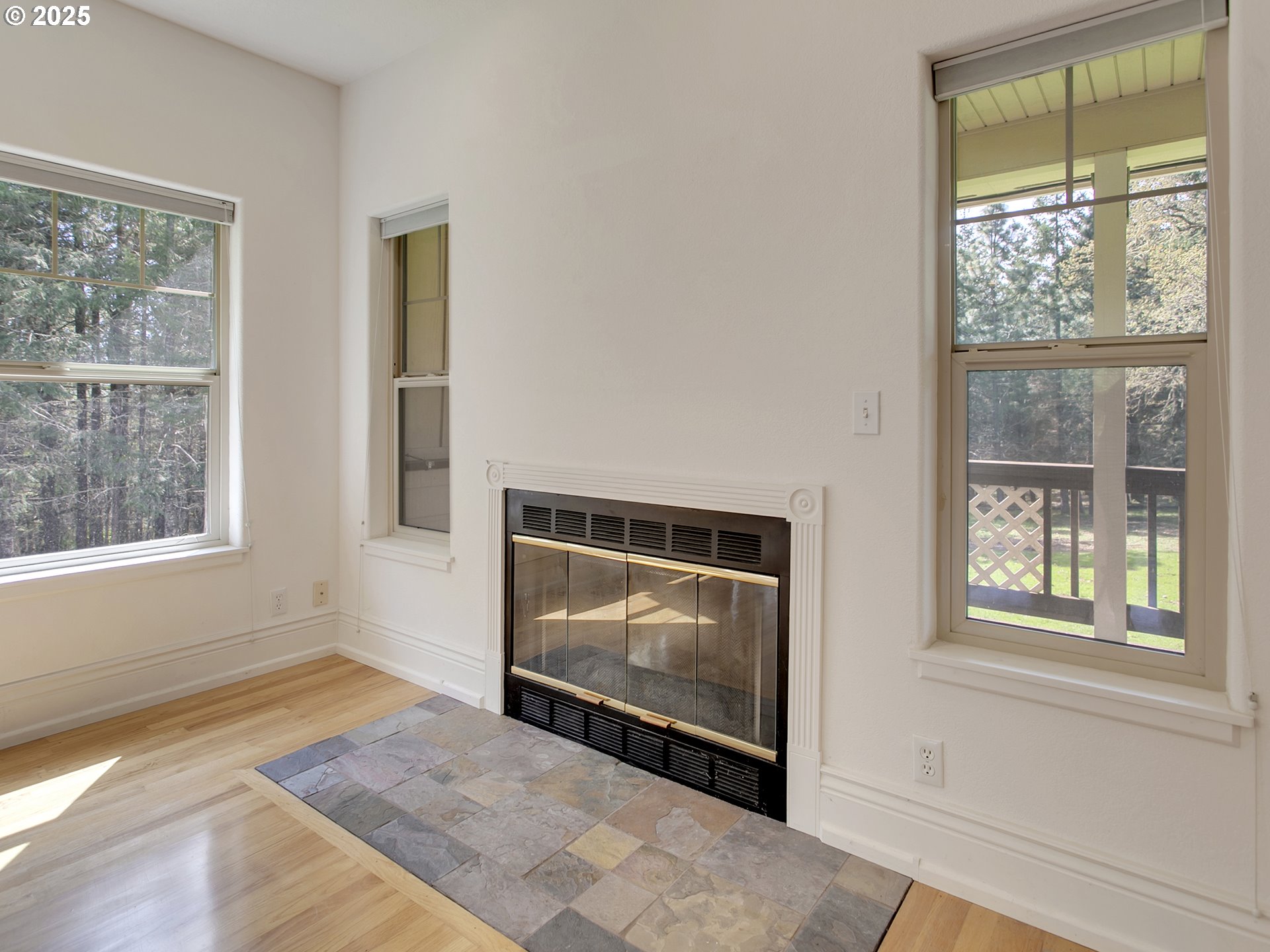 17234 Oakdale Road Dallas, OR 97338 - Photo 8 of 45 a living room with a fireplace and windows