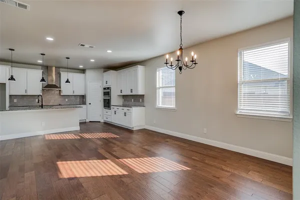 a view of a kitchen with kitchen island sink stainless steel appliances and cabinets