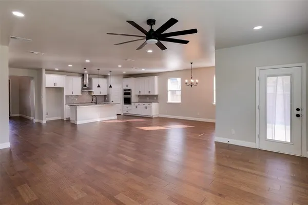 a view of a kitchen with a stove and a ceiling fan
