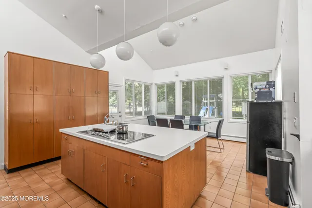 a dining hall with granite countertop a stove and refrigerator