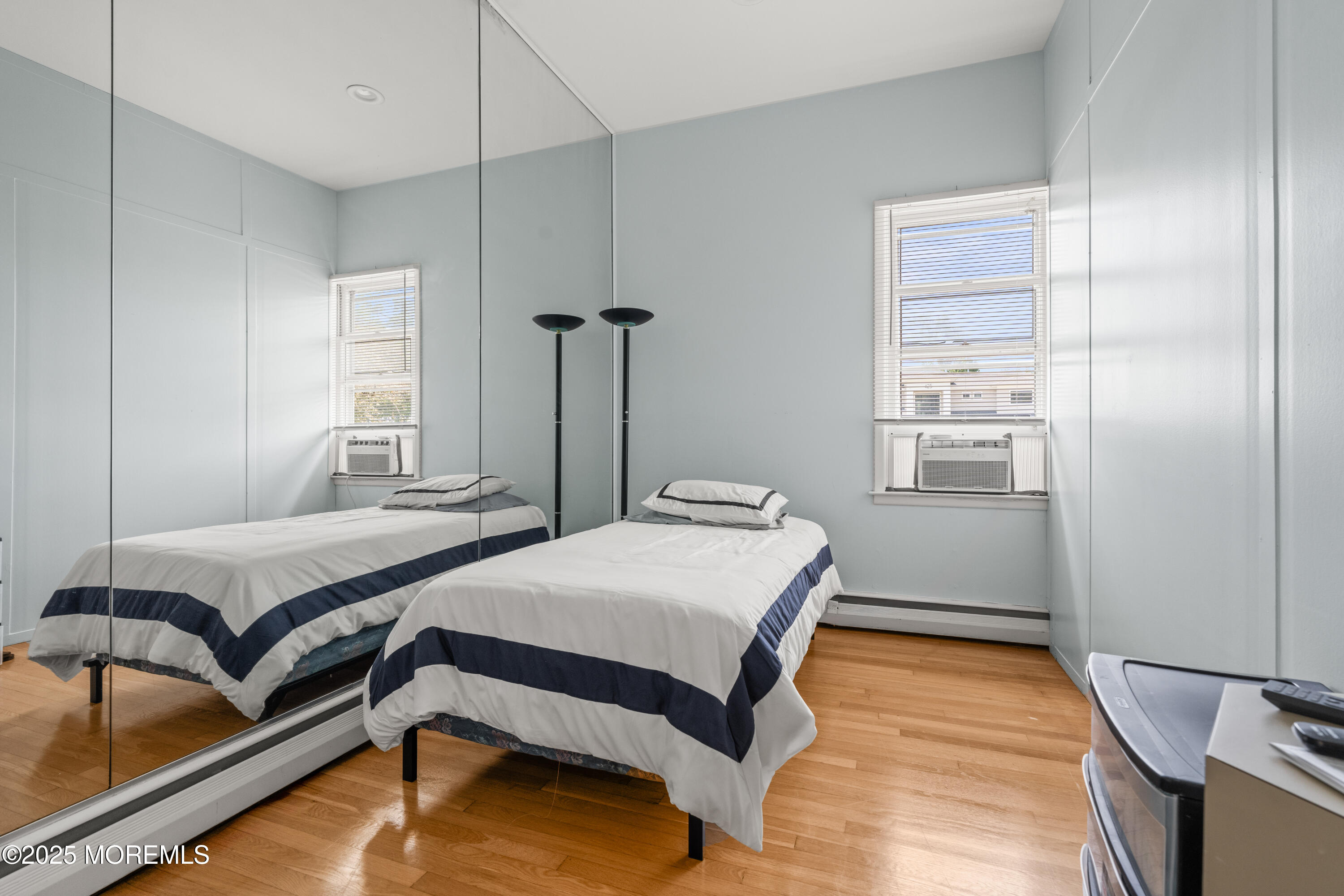 460 Runyan Avenue Deal, NJ 07723 - Photo 18 of 30 a bedroom with a bed and wooden floor