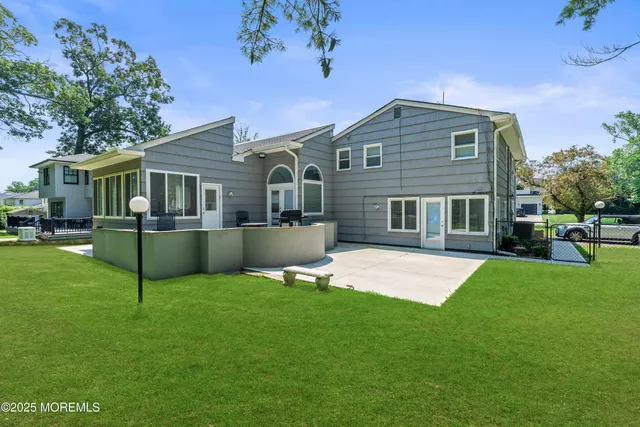 a front view of house with yard and green space