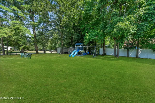 a view of house with a backyard