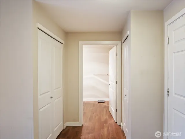 a view of a hallway with wooden floor