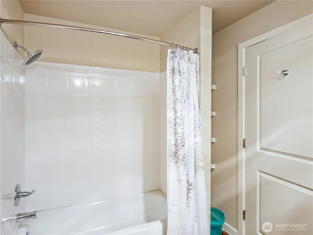 a bathroom with a shower and a tub