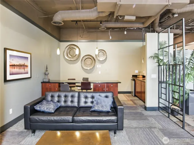 a living room with furniture and a clock