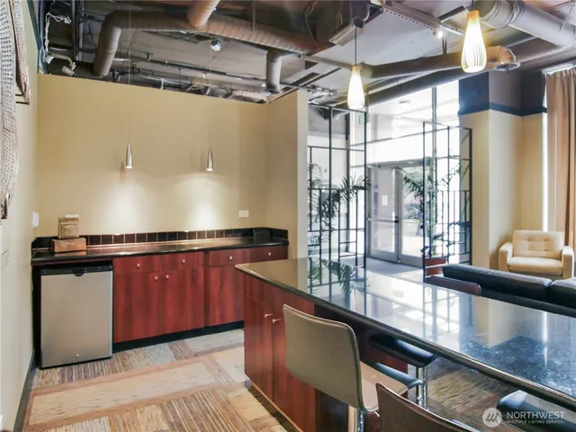 a kitchen with stainless steel appliances granite countertop a sink and a counter space
