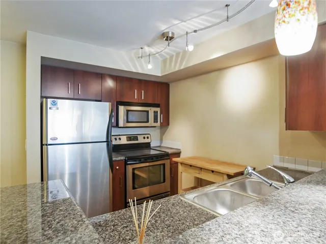 a kitchen with a refrigerator sink and stove