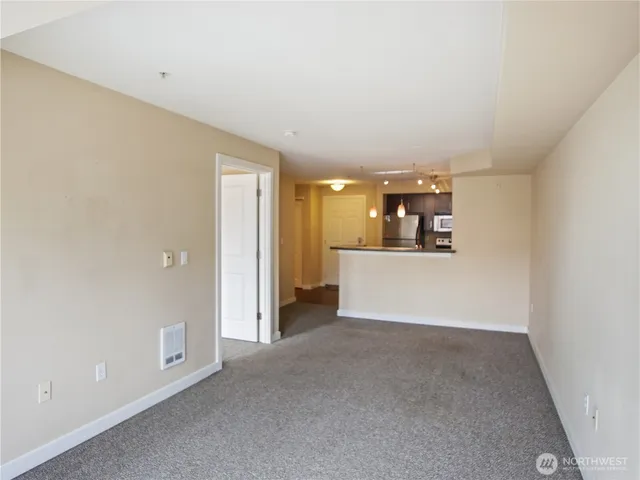 a view of a kitchen with a refrigerator and a kitchen counter top space