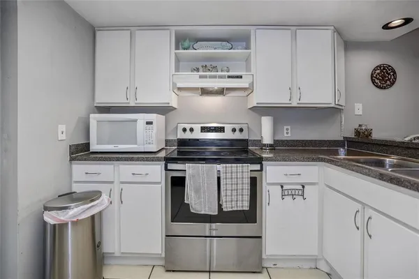 a kitchen with stainless steel appliances granite countertop a stove and a refrigerator
