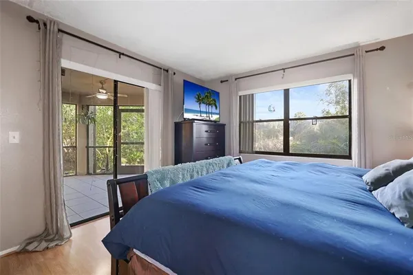 a bed sitting in a bedroom next to a window