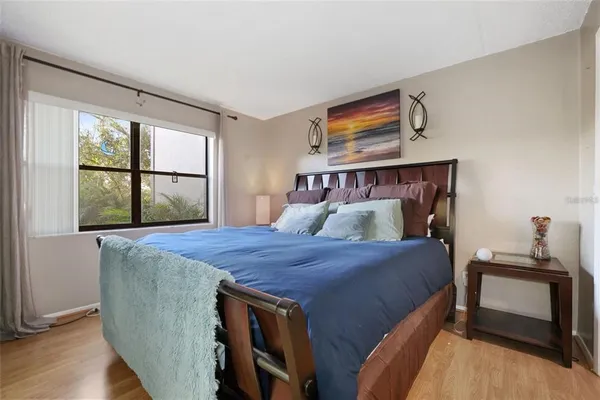 a bed sitting in a bedroom next to a window