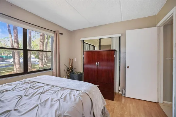 a bedroom with a large bed and a window
