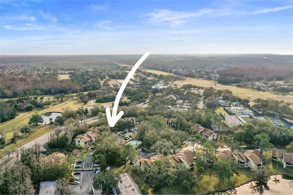 an aerial view of residential houses with outdoor space