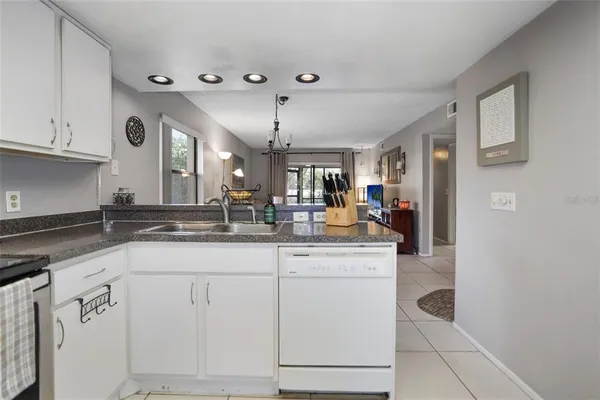 a kitchen with granite countertop a sink and cabinets