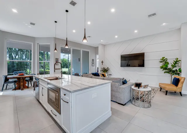 a kitchen with stainless steel appliances granite countertop white cabinets and a stove