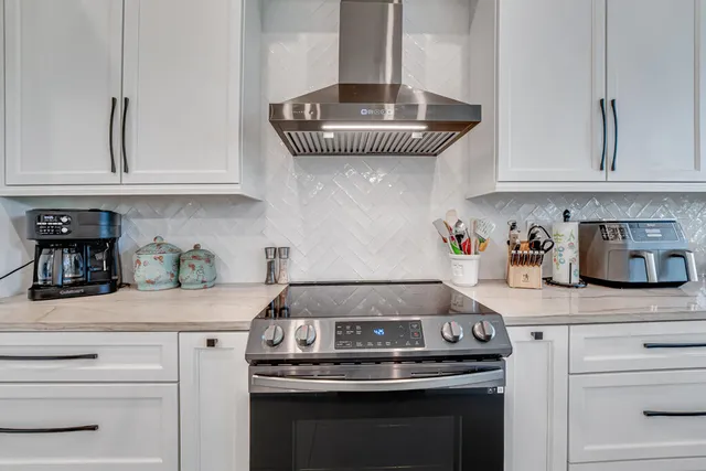 a kitchen with kitchen island a sink appliances and cabinets