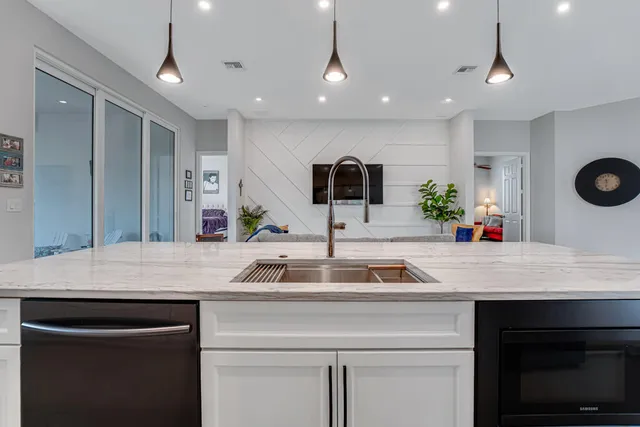 a kitchen with a stove and chairs