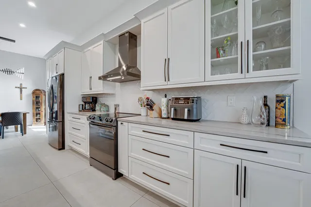 a view of a kitchen with a table and chairs