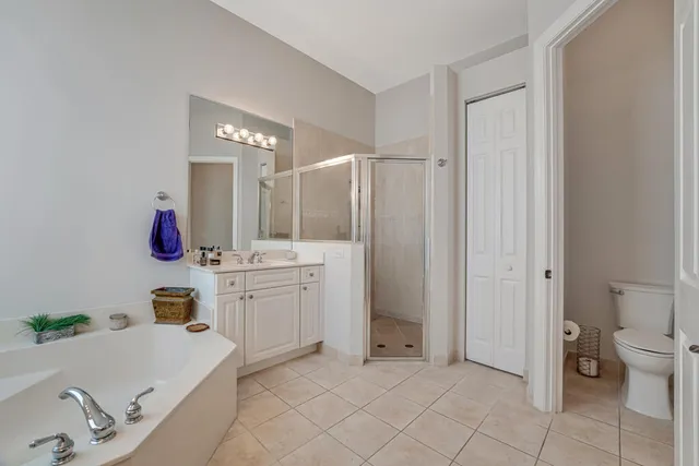 a bathroom with a bathtub sink vanity and mirror