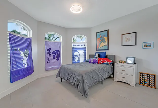 a bedroom with a bed and a painting