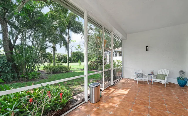 a view of a porch with chairs and backyard