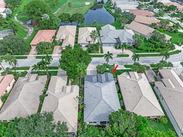 an aerial view of residential houses with outdoor space and trees