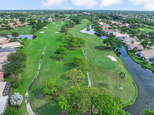an aerial view of city lake and trees