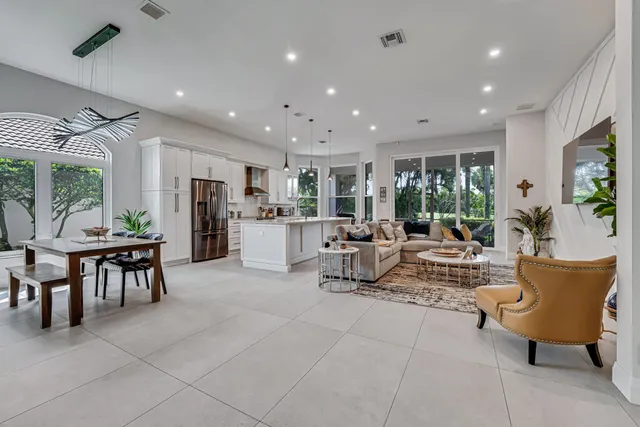 a view of a livingroom with furniture and a table in it