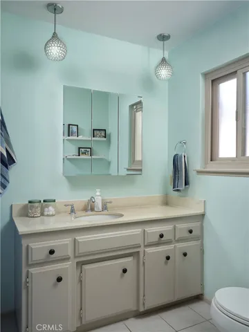 a bathroom with a sink a mirror and vanity
