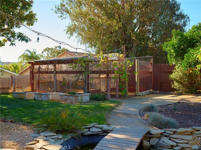 a view of a house with a yard and sitting area