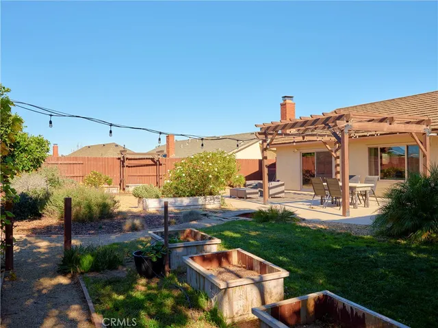 a view of a patio with table and chairs potted plants