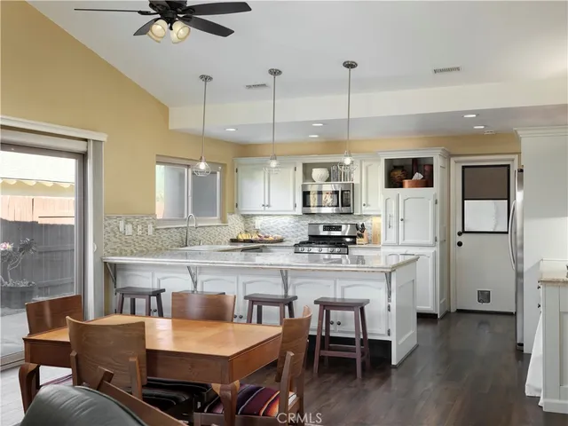 a large kitchen with a table and chairs