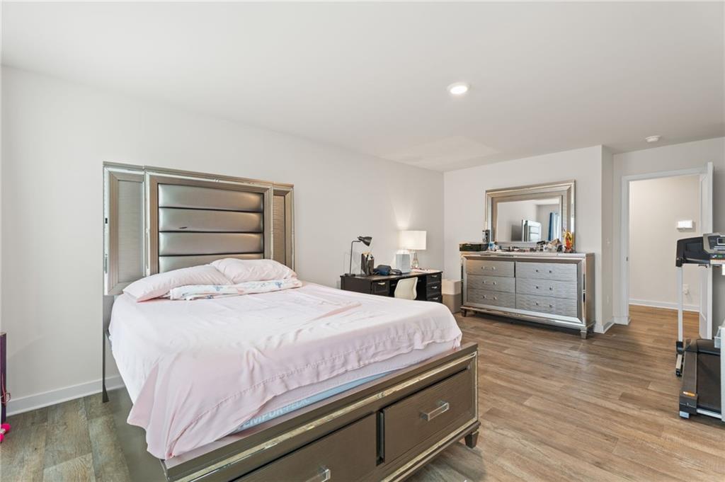 1149 Bluecoat Circle Hampton, GA 30228 - Photo 11 of 21 a bedroom with a bed and a view of kitchen