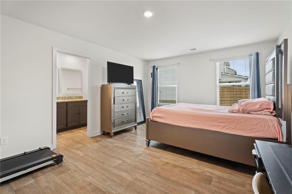 1149 Bluecoat Circle Hampton, GA 30228 - Photo 12 of 21 a bedroom with a bed and a television