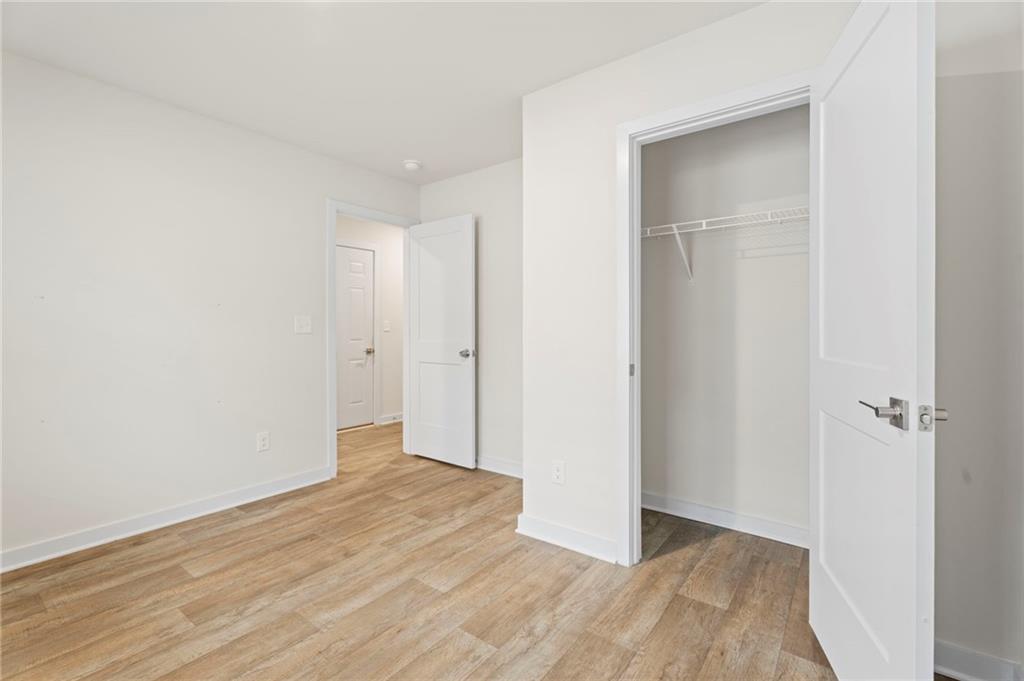 1149 Bluecoat Circle Hampton, GA 30228 - Photo 14 of 21 a view of a room with wooden floor and closet