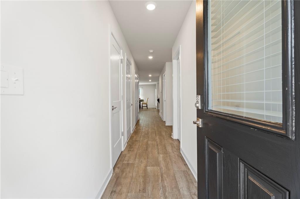 1149 Bluecoat Circle Hampton, GA 30228 - Photo 4 of 21 a view of a hallway with wooden floor and a bathroom