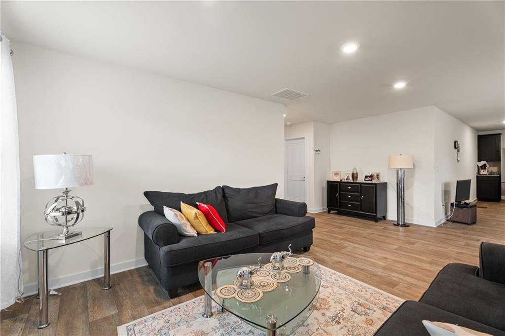 1149 Bluecoat Circle Hampton, GA 30228 - Photo 9 of 21 a living room with furniture and wooden floor