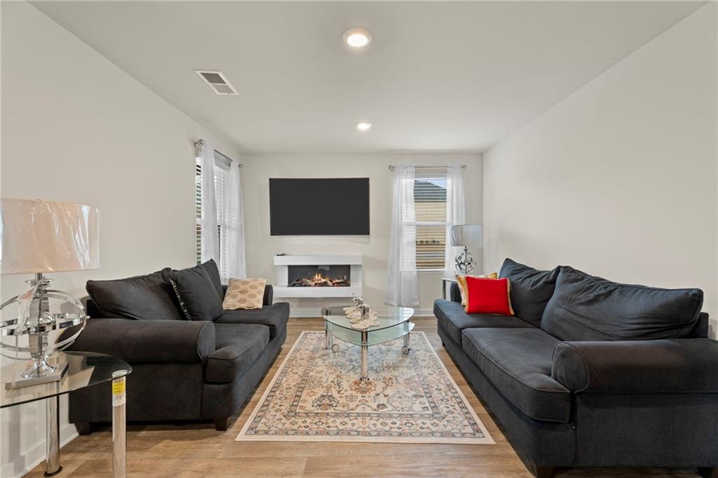 1149 Bluecoat Circle Hampton, GA 30228 - Photo 10 of 21 a living room with furniture and a flat screen tv