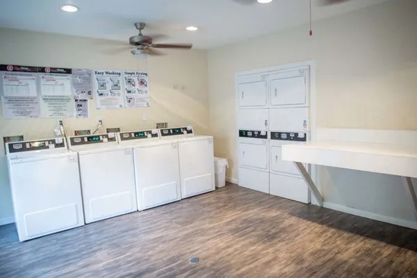 a kitchen with stainless steel appliances a sink a stove a refrigerator and cabinets