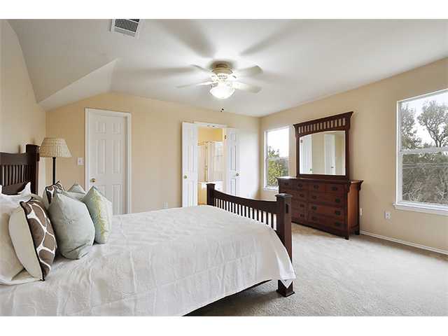 2609 Gate Ridge Drive Austin, TX 78748 - Photo 1 of 1 a bedroom with a bed and a chandelier