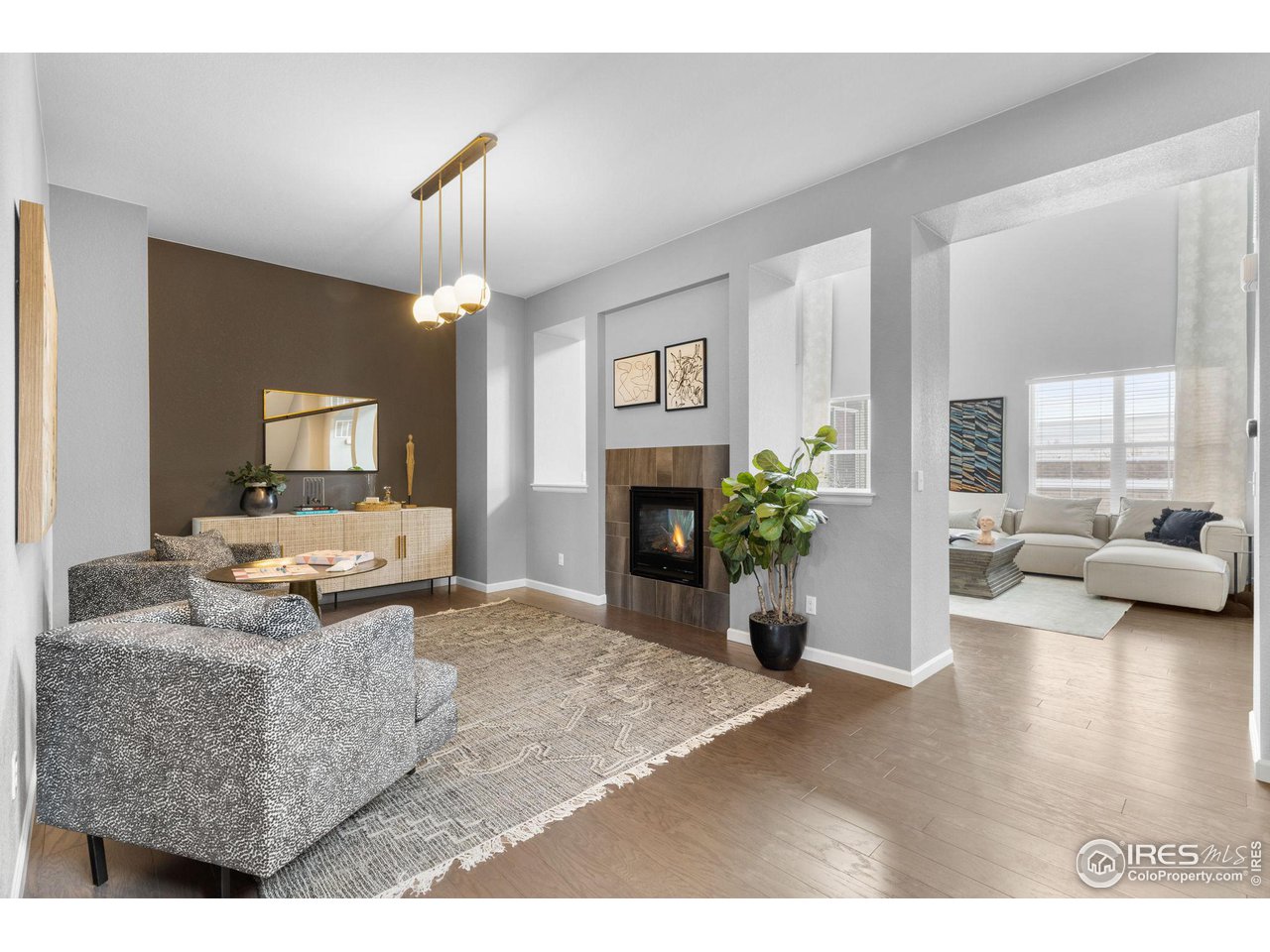 973 Stagecoach Drive Lafayette, CO 80026 - Photo 15 of 39 a living room with furniture a fireplace and a chandelier