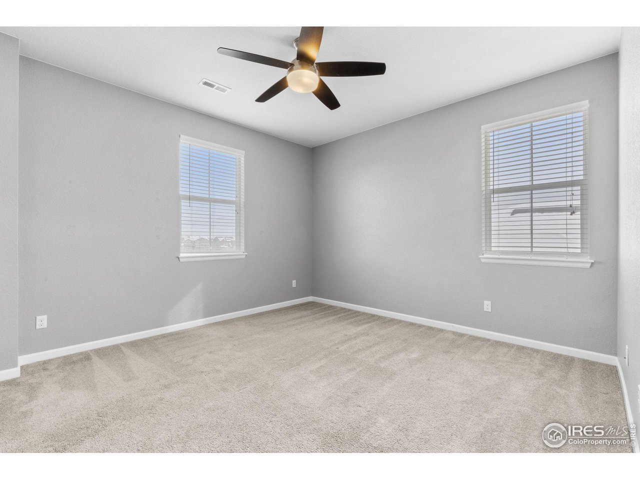 973 Stagecoach Drive Lafayette, CO 80026 - Photo 24 of 39 an empty room with windows and ceiling fan