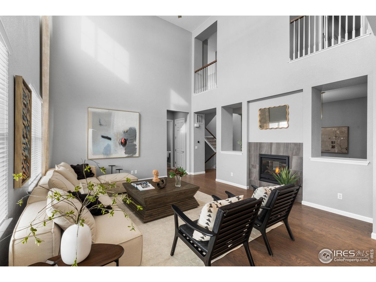 973 Stagecoach Drive Lafayette, CO 80026 - Photo 4 of 39 a living room with furniture a fireplace and a table