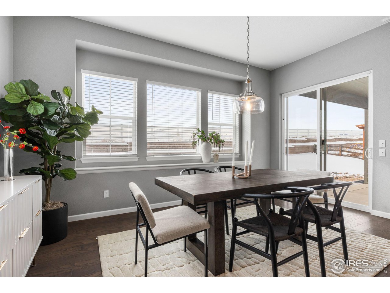 973 Stagecoach Drive Lafayette, CO 80026 - Photo 10 of 39 a dining room with furniture potted plants and wooden floor