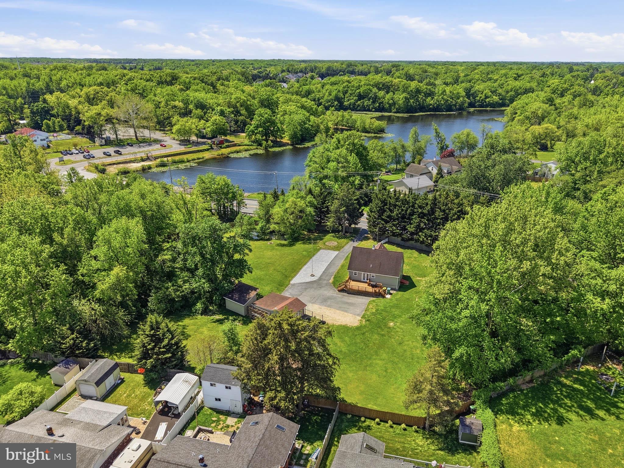 768 Salem Church Road Newark, DE 19702 - Photo 5 of 42 Serene lakeside retreat surrounded by greenery.